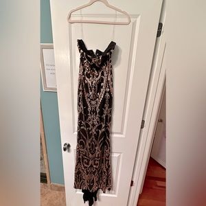 Never been worn floor length black and gold sequenced gown.